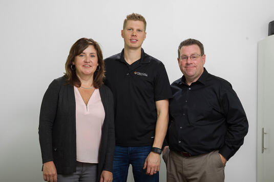 Founders of First Call Heating standing together in the office